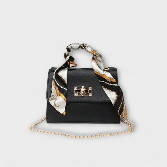 Black faux leather handbag with scarf handle and chain strap.