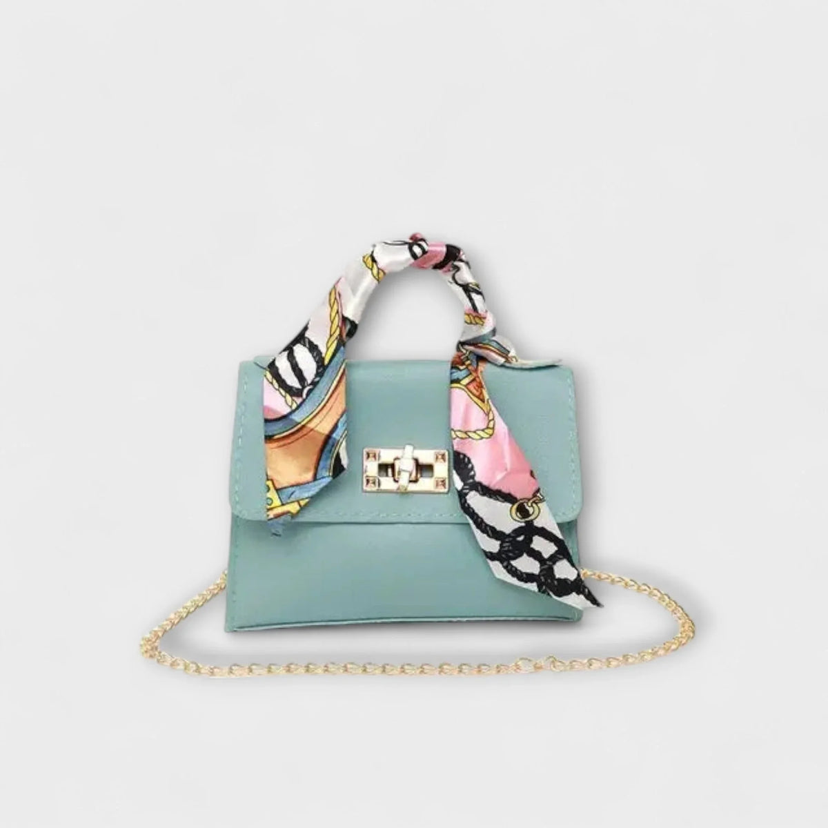 Blue faux leather handbag with scarf handle and chain strap.