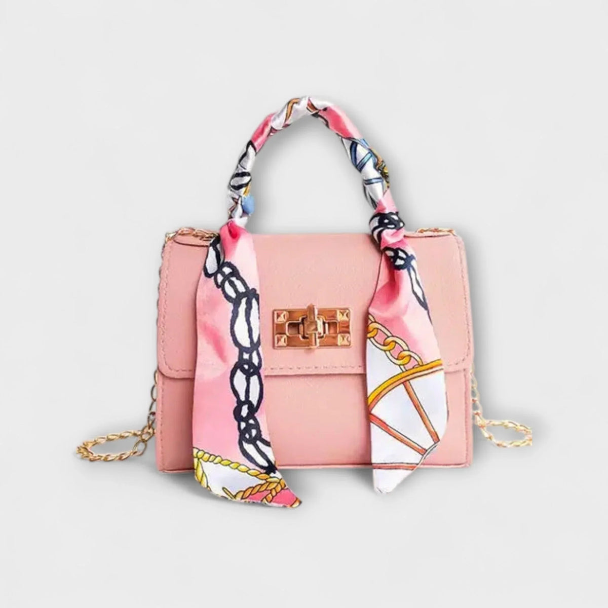 Pink faux leather handbag with scarf handle and chain strap.
