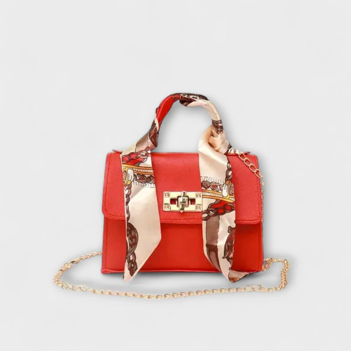 Red faux leather handbag with scarf handle and chain strap.