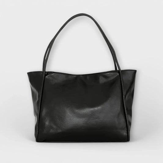 Black faux-leather tote bag with open-top and thin shoulder straps.