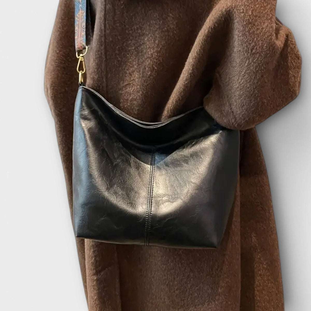 Brown faux leather hobo shoulder bag, wide geometric strap.