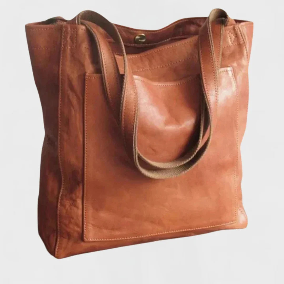 Brown leather tote bag with front patch pocket, double shoulder straps.