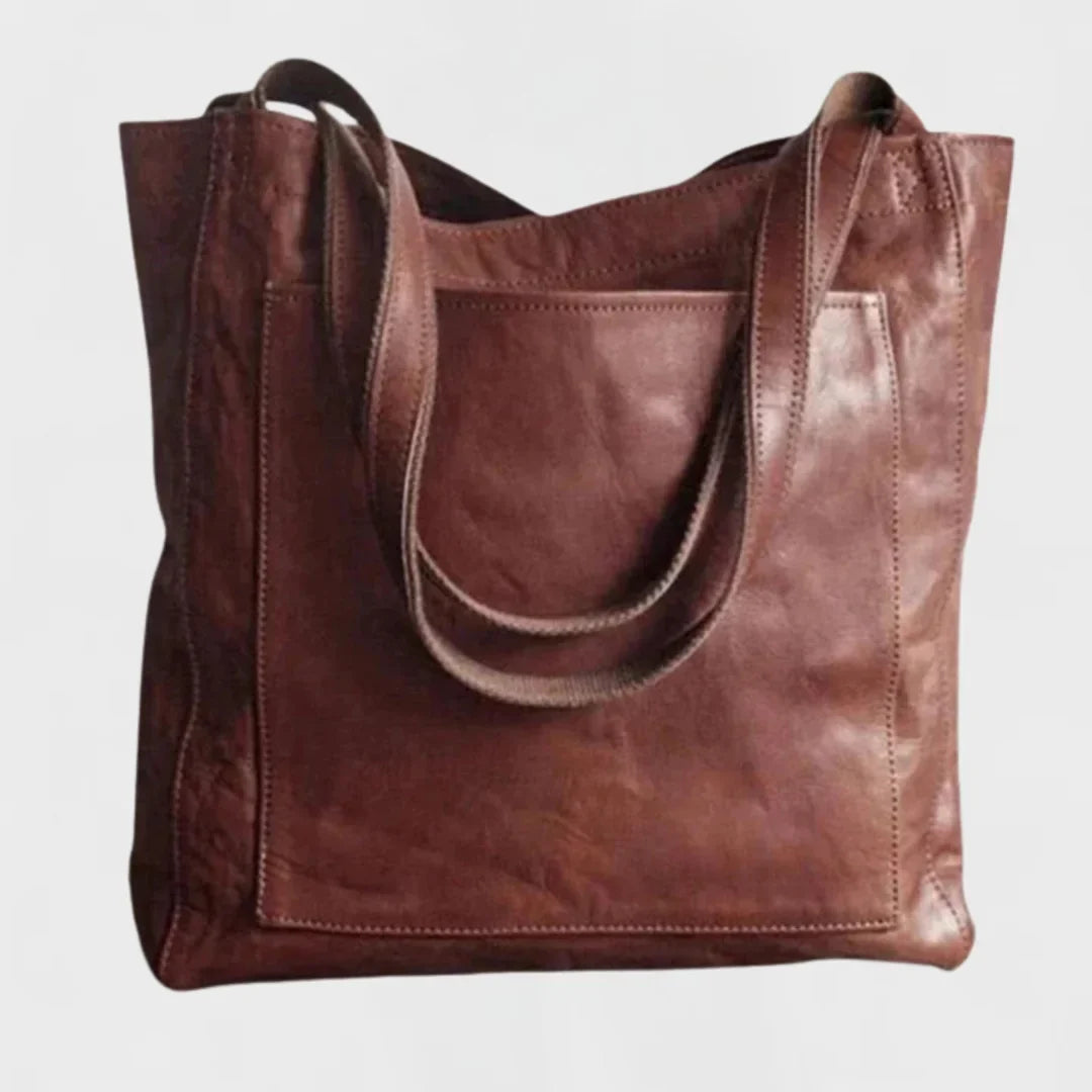Women's brown leather tote with front patch pocket, double shoulder straps.