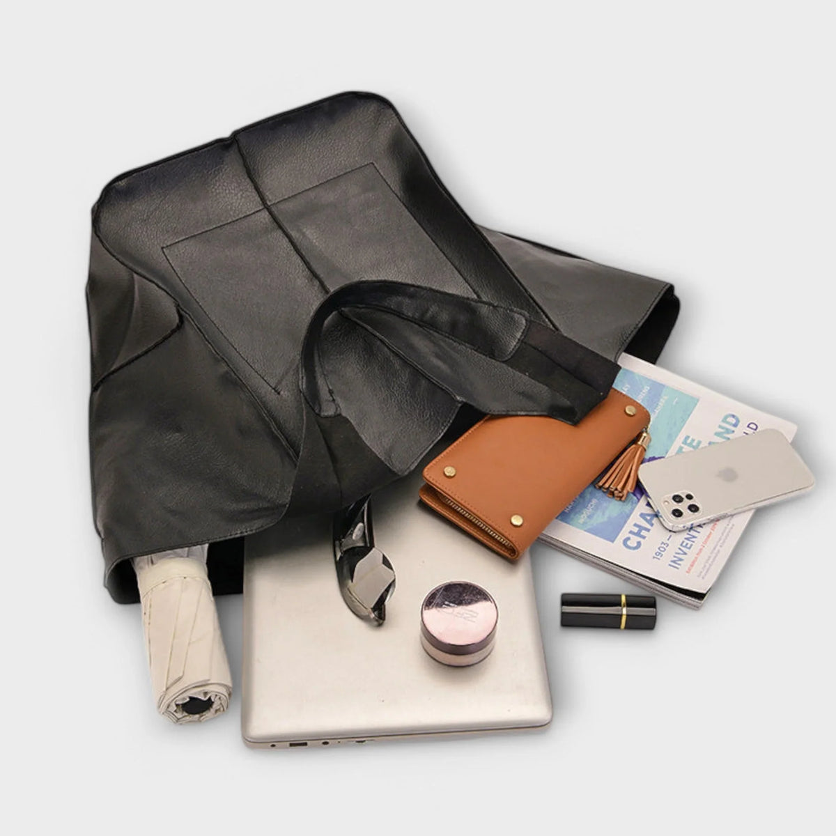 Black faux leather tote bag with two exterior slip pockets.