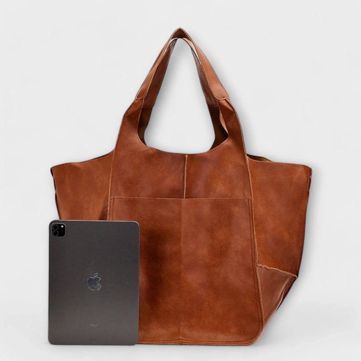 Large black faux leather tote with two exterior slip pockets.