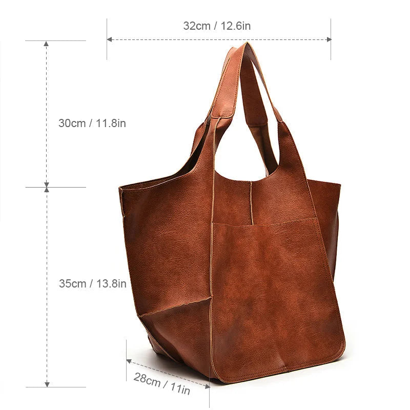 Large black faux leather tote bag with two exterior slip pockets.