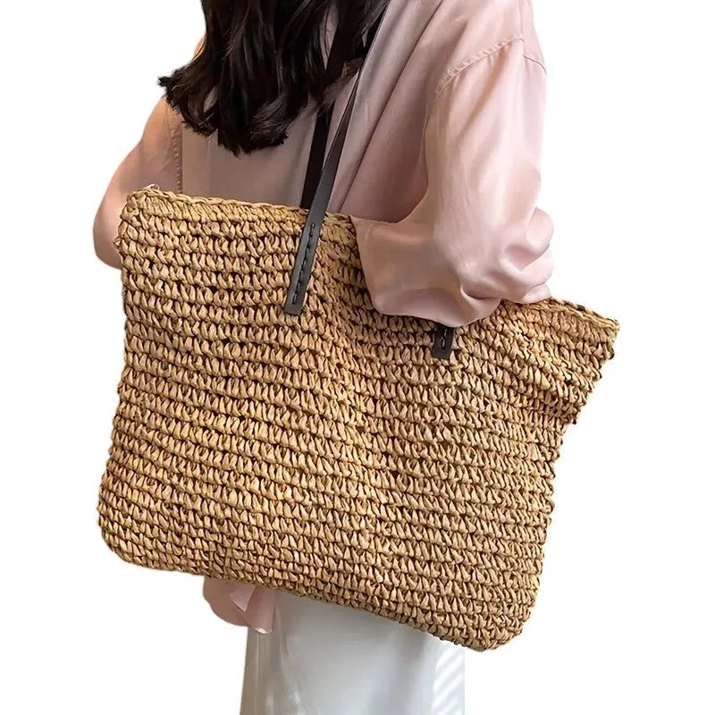 Spacious woven straw tote bag with double faux-leather straps.