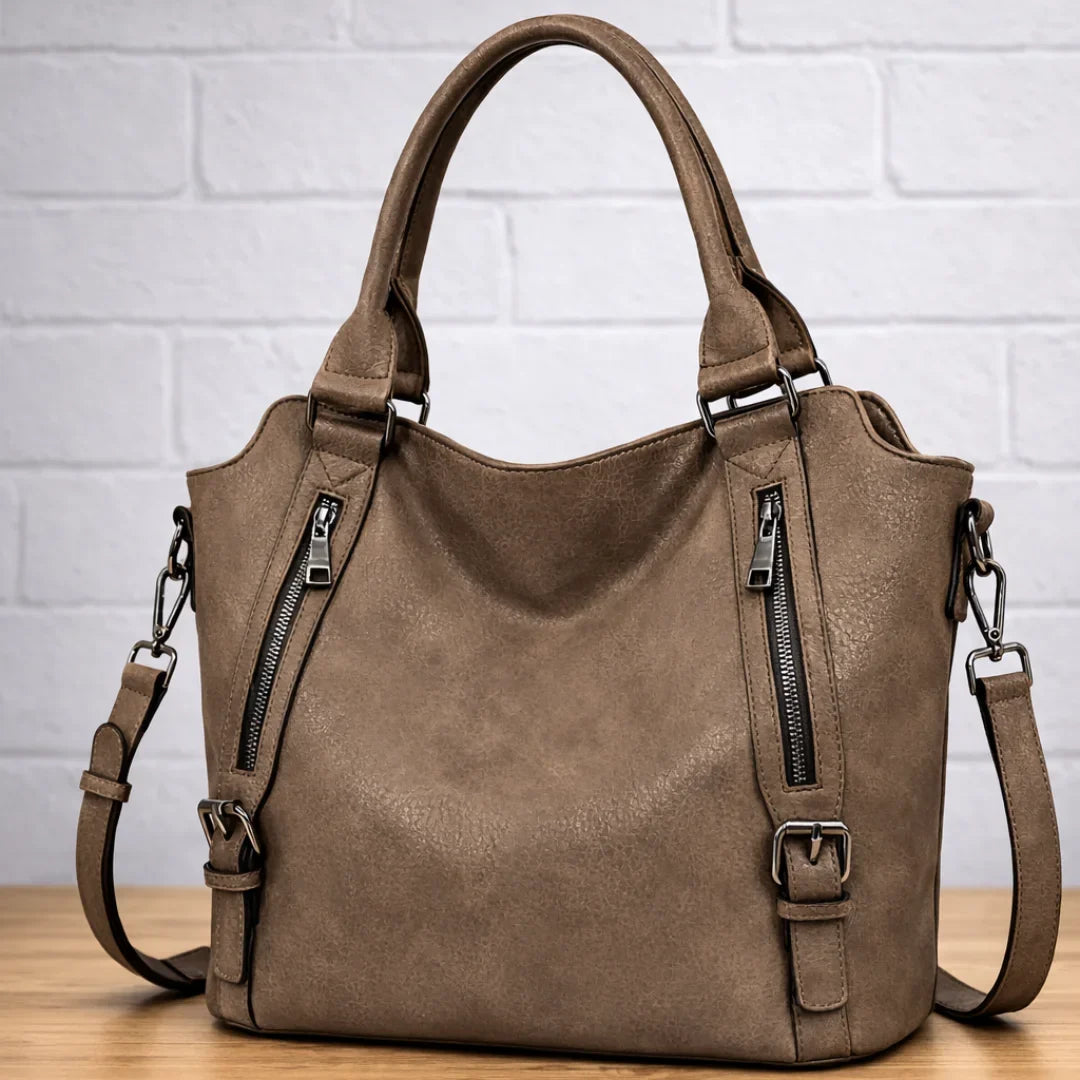 Coffee faux-leather slouchy crossbody bag with dual zip pockets.