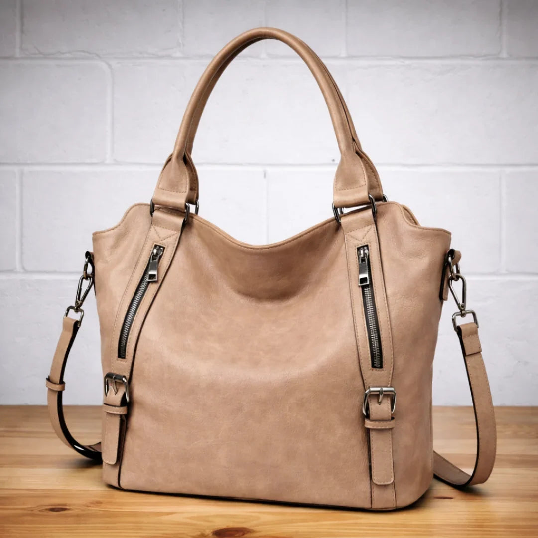 Tan faux-leather slouchy crossbody shoulder bag, dual zip pockets.