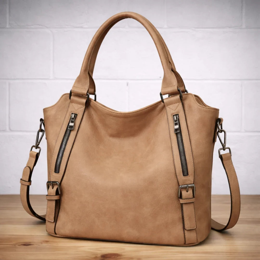 Oatmeal faux-leather slouchy crossbody with dual zip pockets.