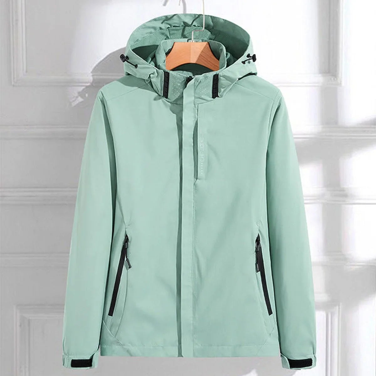 Women's waterproof hooded adjustable-fit rain jacket in Mint Green