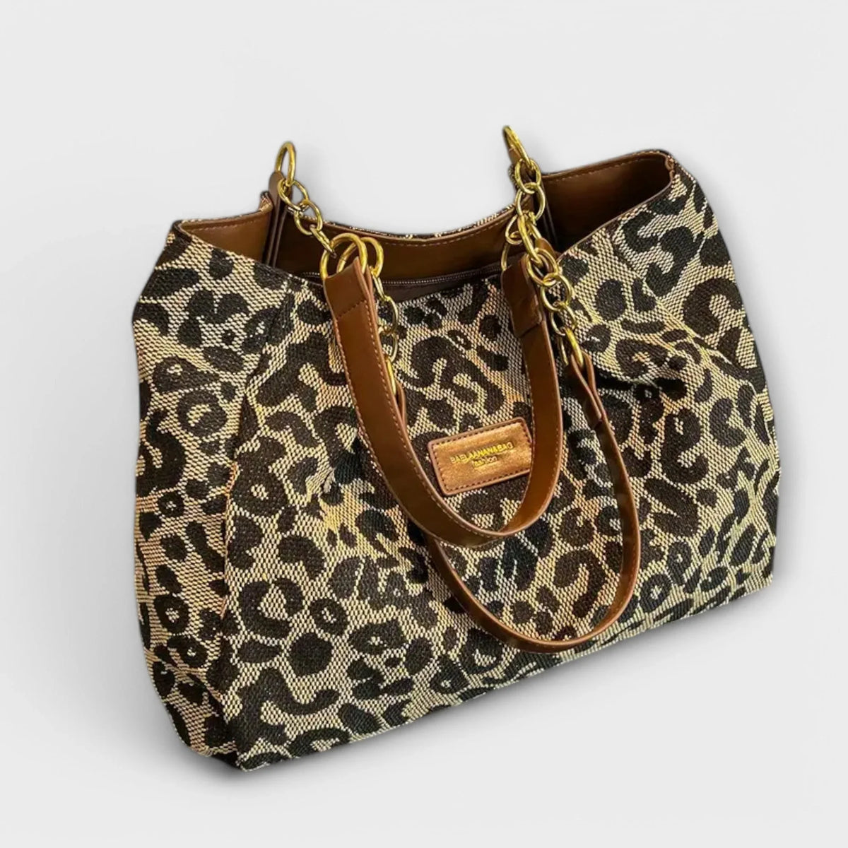 Woven leopard print shoulder bag with brown faux-leather chain handles.