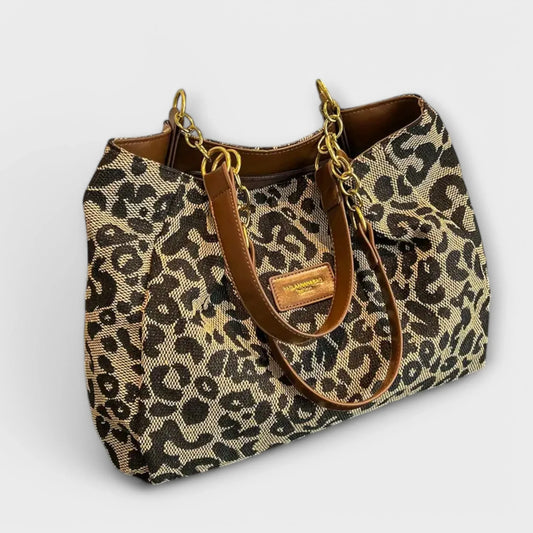 Woven leopard print shoulder bag with brown faux-leather chain handles.
